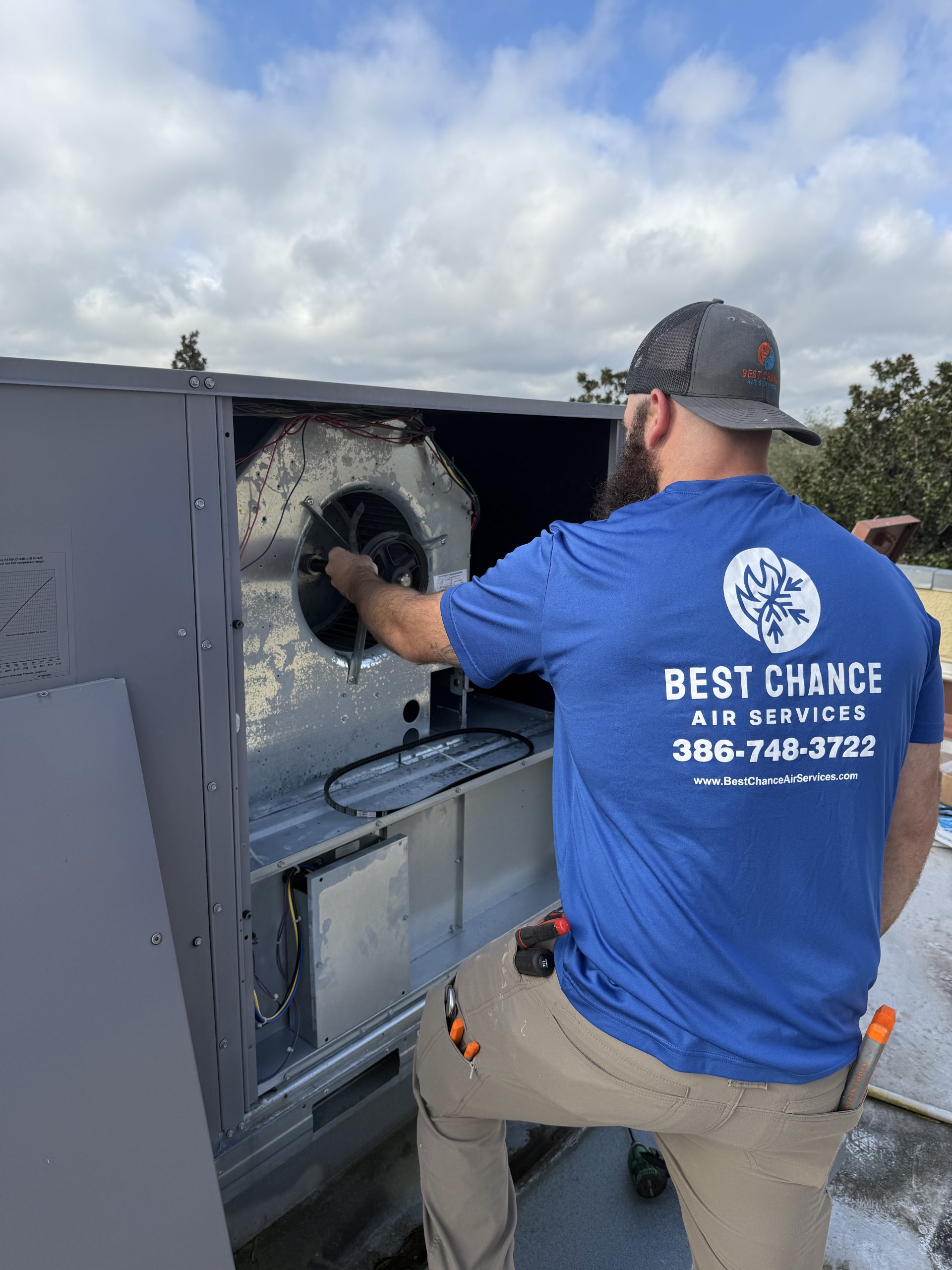 Best Chance Air Services technician working on rooftop commercial unit