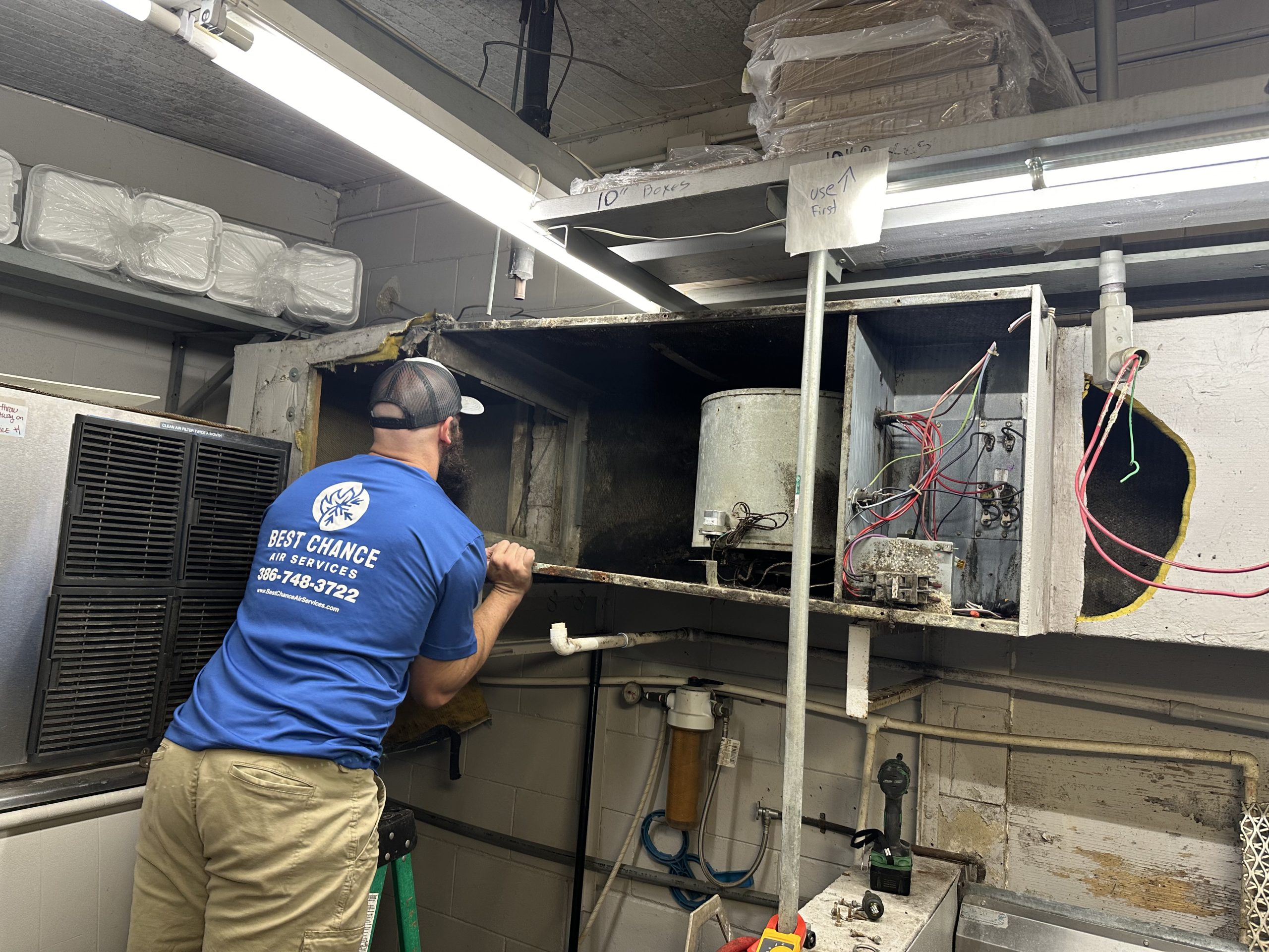 Best Chance Air Services technician working on commercial kitchen HVAC