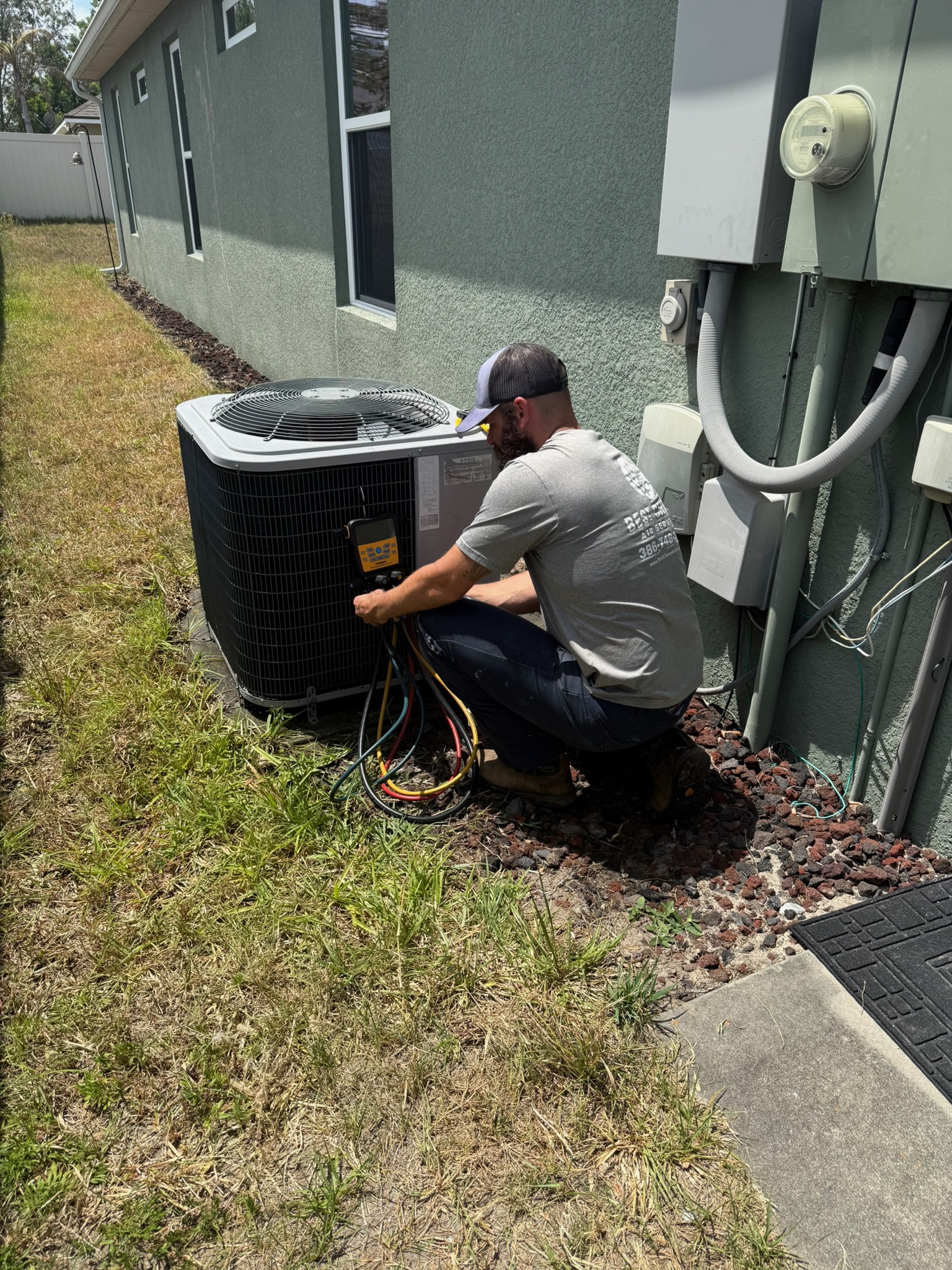 AC blowing hot air technician checking outdoor condenser unit